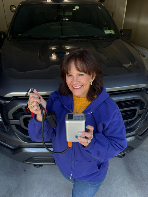 The JumpAir Pro in one hand, clamps in the other — small enough to carry in from the car